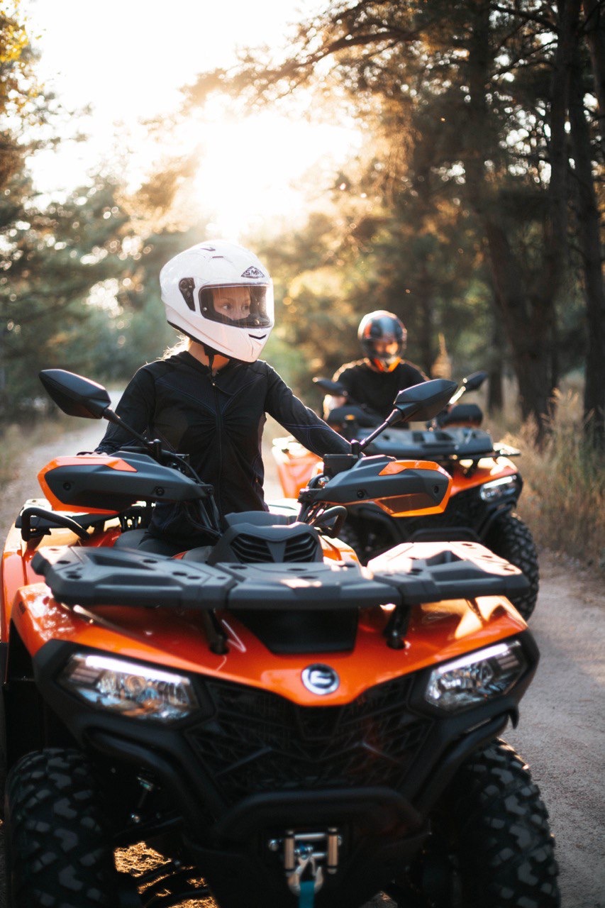 Guests riding quad bikes through the forest